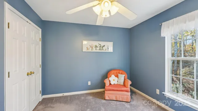 an empty room with window and ceiling fan