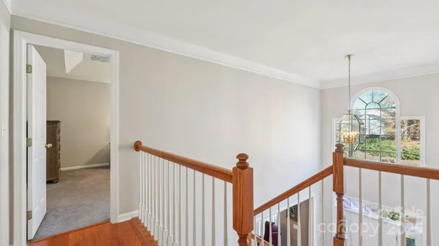 a view of a hallway to a room with windows