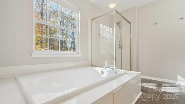 a bathroom with a granite countertop sink and a bathtub