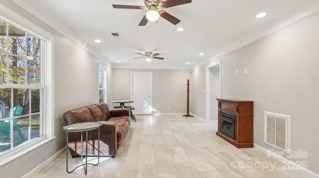 a living room with furniture and a ceiling fan