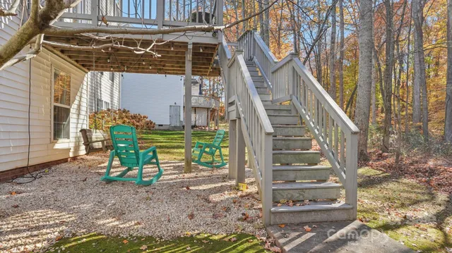 a view of a house with a yard and stairs