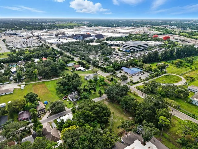 an aerial view of residential houses with outdoor space and swimming pool