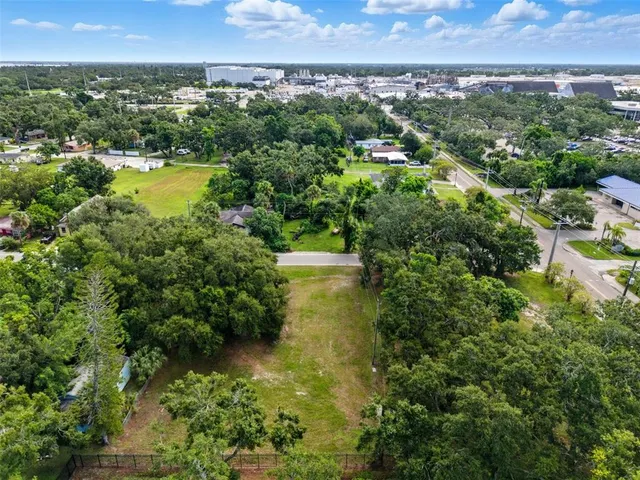 an aerial view of residential houses with outdoor space and swimming pool