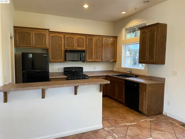 a kitchen with a sink a stove and a microwave