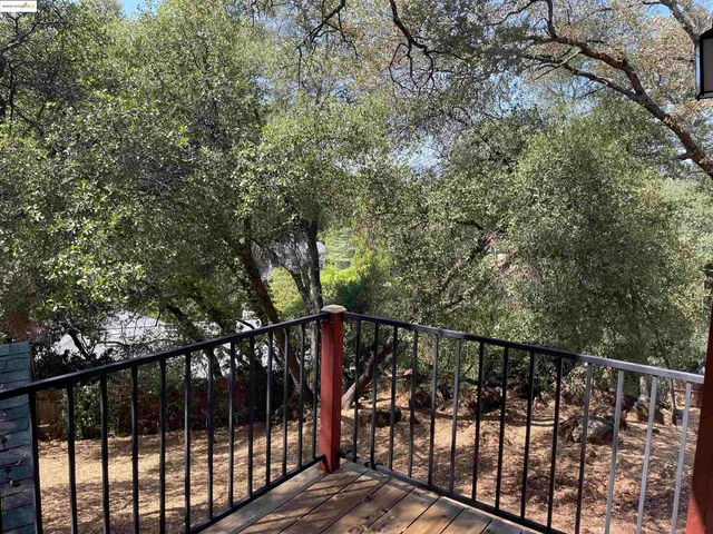 a view of a balcony with trees