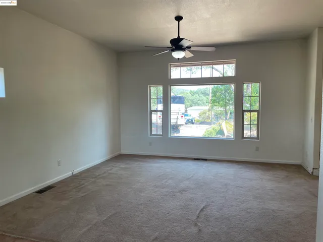 a view of an empty room with windows