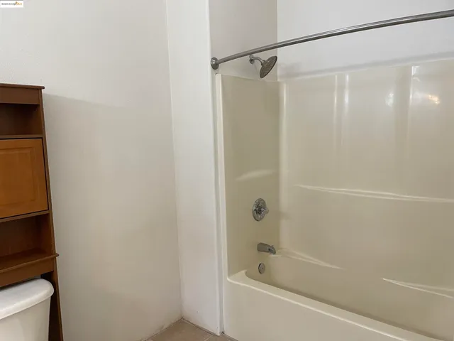a bathroom with a toilet and a bathtub