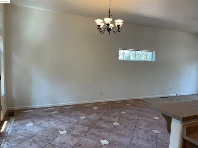 a view of empty room with chandelier