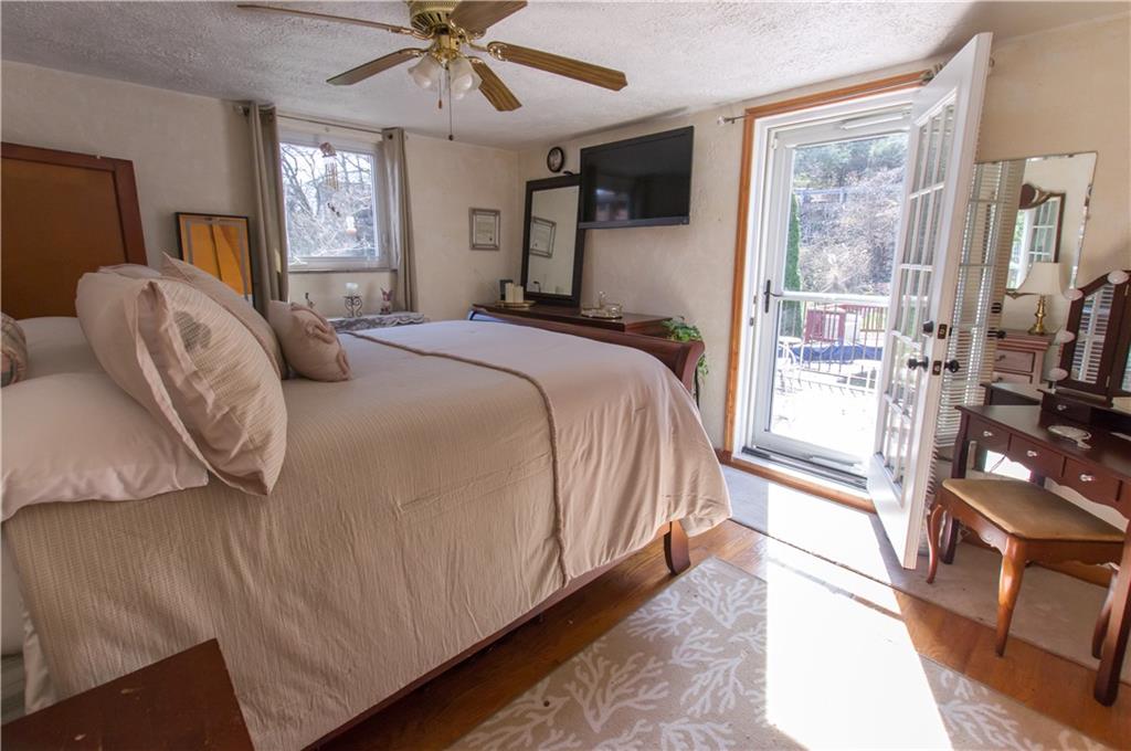 931 Liberty Street McKees Rocks, PA 15136 - Photo 20 of 41 a bedroom with a large bed and a chandelier