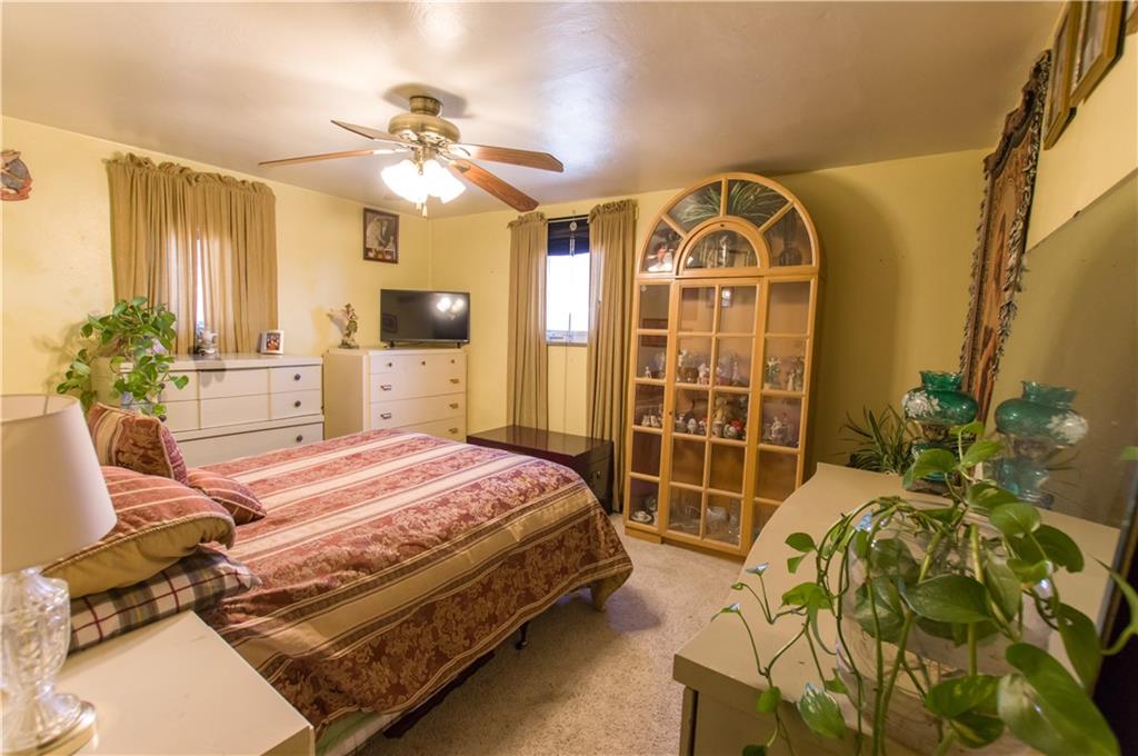 931 Liberty Street McKees Rocks, PA 15136 - Photo 23 of 41 a bedroom with a bed and a chandelier