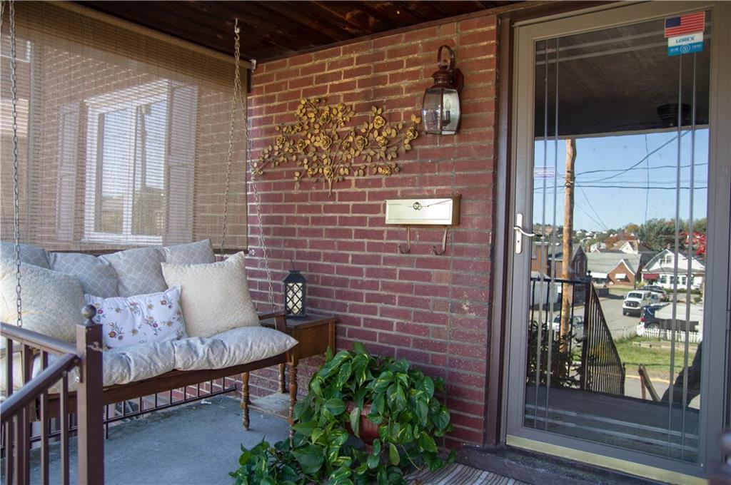 931 Liberty Street McKees Rocks, PA 15136 - Photo 3 of 41 a brick building with a bench and potted plant