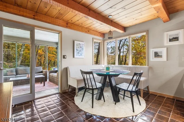 a view of a dining room with furniture wooden floor and a chandelier