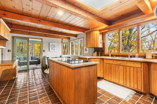 a kitchen with stainless steel appliances granite countertop a stove a sink dishwasher and cabinets with wooden floor