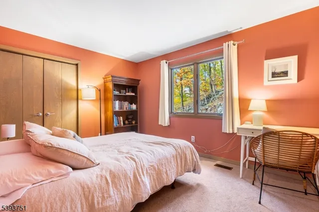 a bedroom with a large bed and a window