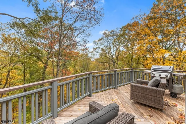 a balcony with wooden floor and furniture