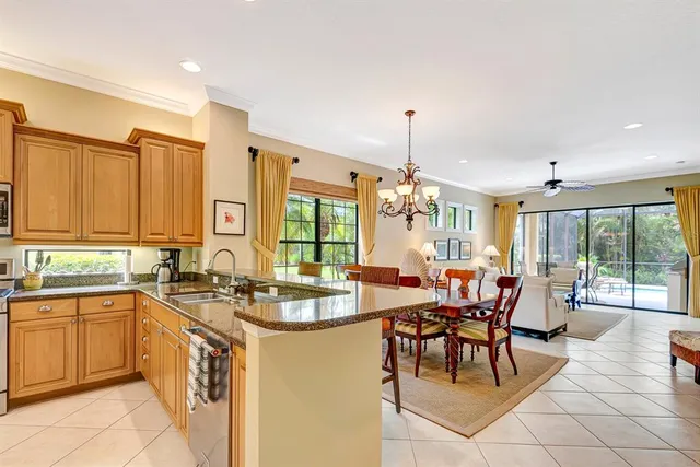 a kitchen with stainless steel appliances granite countertop a refrigerator a sink and dishwasher