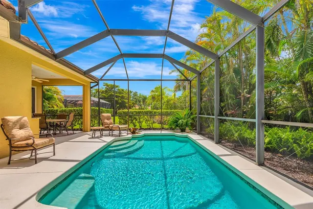 an aerial view of residential houses with outdoor space and ocean view