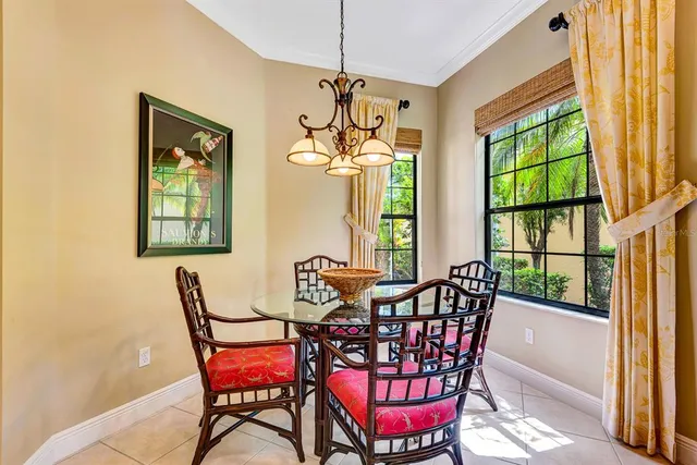 a dining room with furniture a chandelier and wooden floor