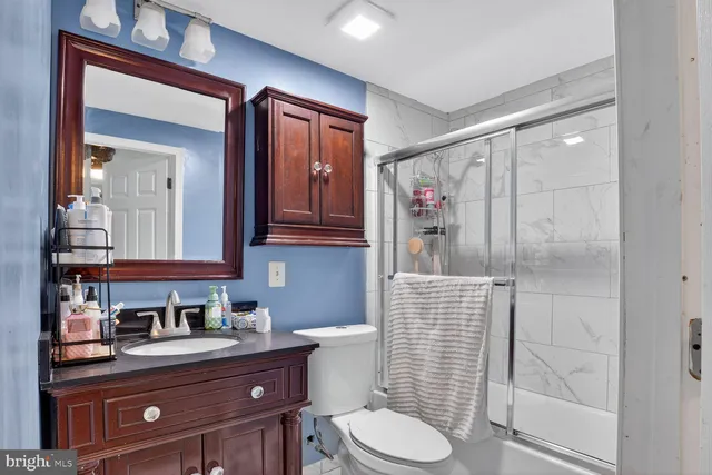 a bathroom with a toilet a sink and shower