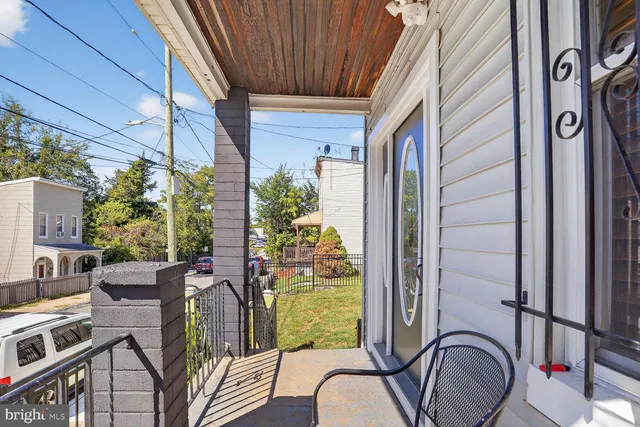 a balcony view with couple of chairs and potted plants