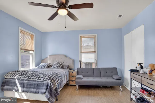 a bedroom with a bed and a couch