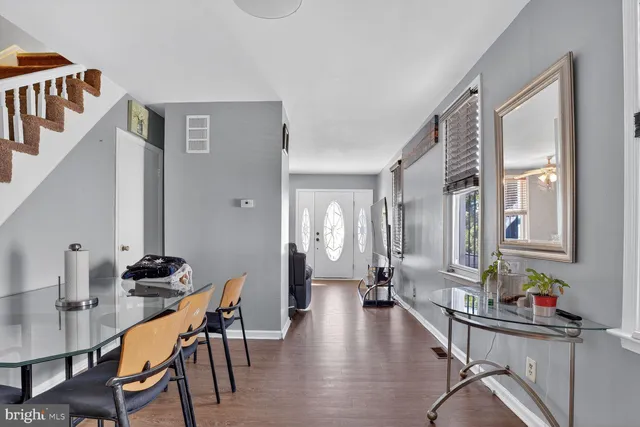 a dining room with furniture and wooden floor