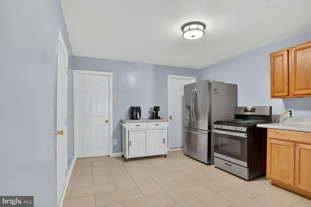 a kitchen with a stove sink and refrigerator