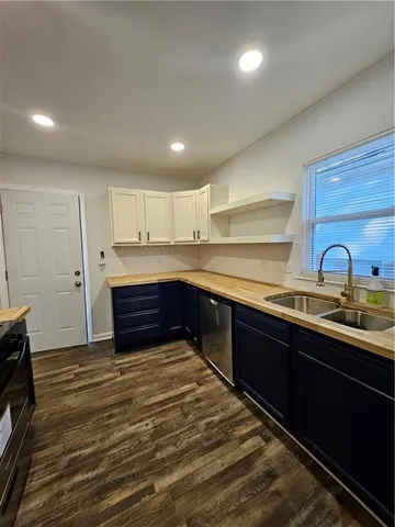 a kitchen with stainless steel appliances granite countertop a sink stove and cabinets
