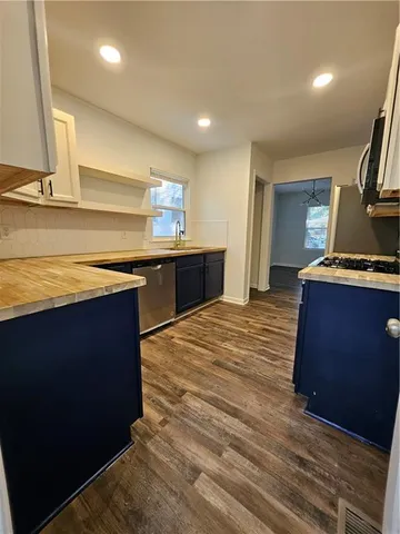 a kitchen with stainless steel appliances granite countertop a stove and a sink