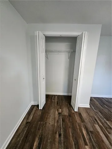 a view of a room with wooden floor and closet
