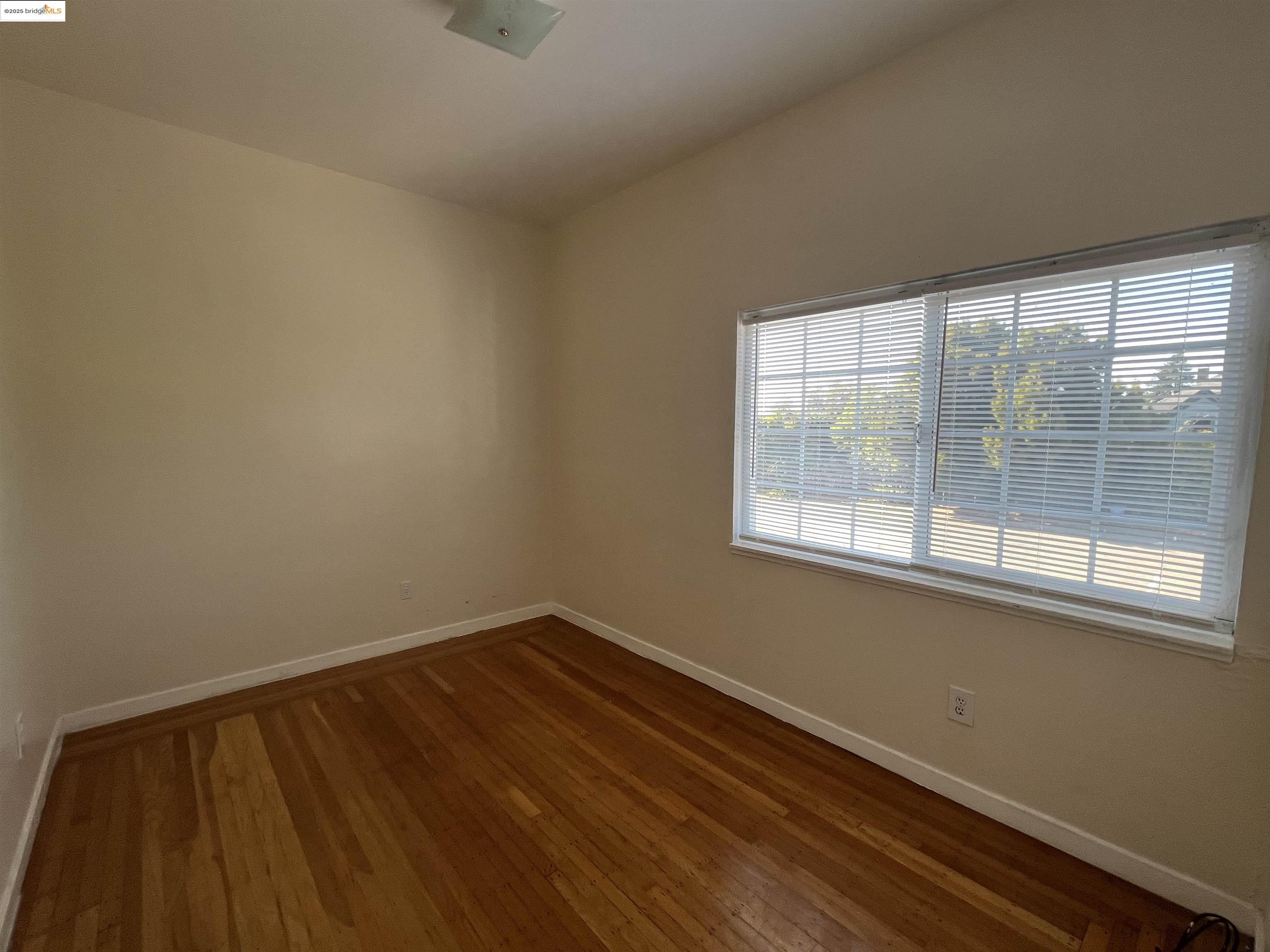 3244 Ellis Street, Unit C Berkeley, CA 94703 - Photo 2 of 4 a view of a room with wooden floor and a window