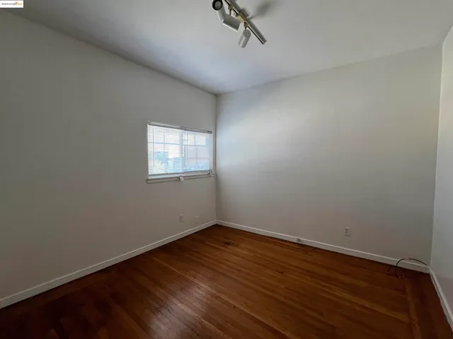a view of a room with wooden floor and windows