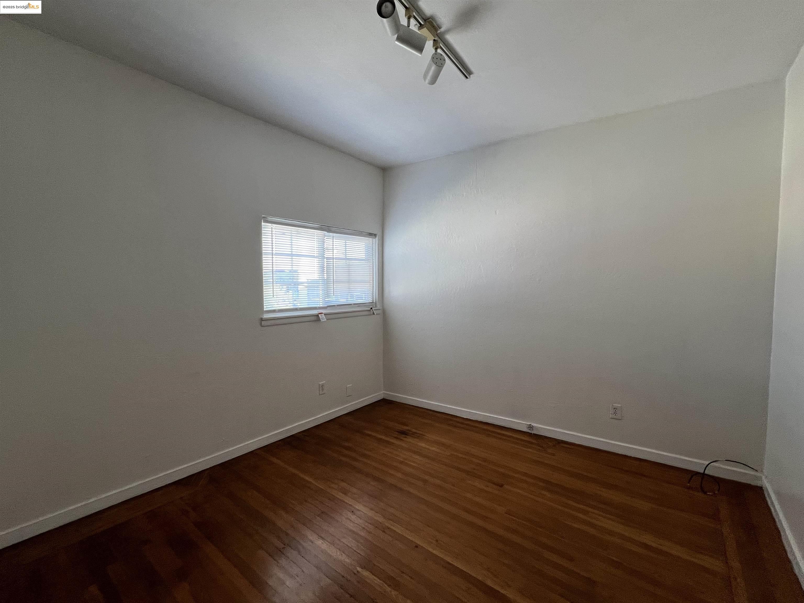 3244 Ellis Street, Unit C Berkeley, CA 94703 - Photo 3 of 4 a view of a room with wooden floor and windows