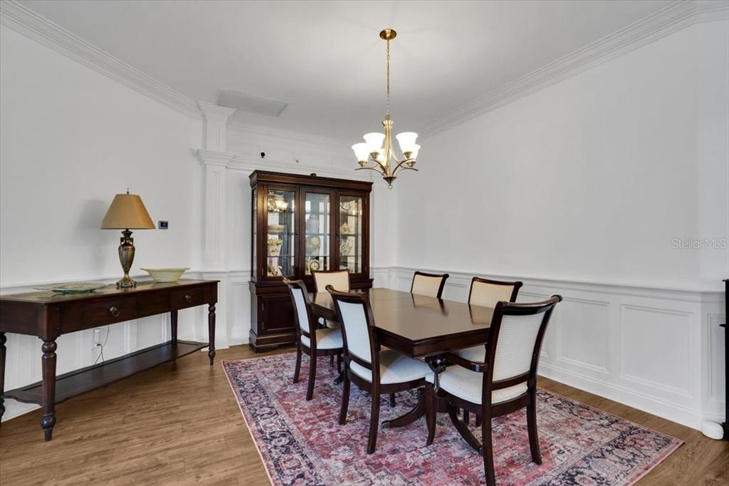 7601 226th Street East Bradenton, FL 34211 - Photo 17 of 50 a view of a dining room with furniture and chandelier
