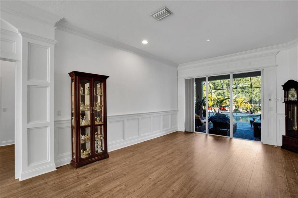 7601 226th Street East Bradenton, FL 34211 - Photo 18 of 50 an empty room with wooden floor and a window