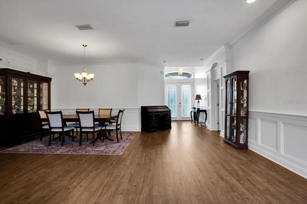 7601 226th Street East Bradenton, FL 34211 - Photo 19 of 50 a view of a dining room with furniture and wooden floor