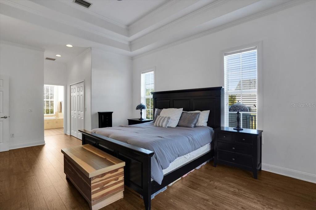 7601 226th Street East Bradenton, FL 34211 - Photo 24 of 50 a bedroom with a bed and wooden floor