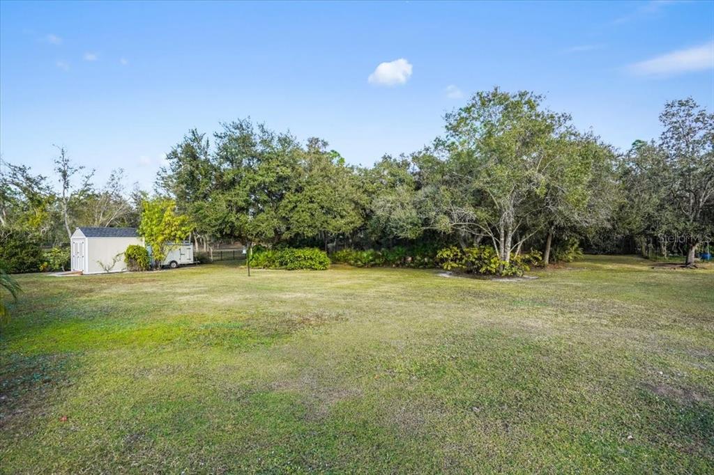 7601 226th Street East Bradenton, FL 34211 - Photo 43 of 50 a view of a field with trees in the background