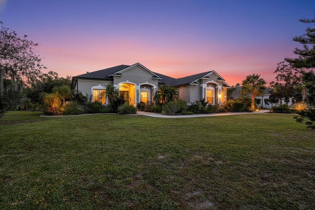 7601 226th Street East Bradenton, FL 34211 - Photo 5 of 50 a front view of a house with a yard
