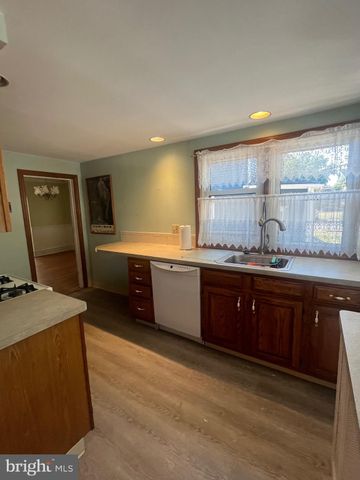 a spacious bathroom with a granite countertop sink a mirror and a bathtub