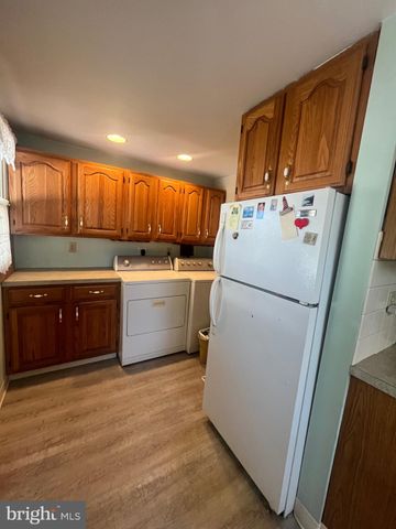 a white refrigerator freezer sitting inside of a kitchen