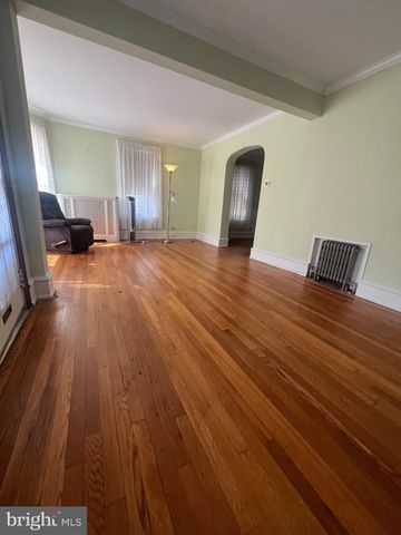 a view of a livingroom with wooden floor and furniture