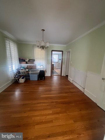 a living room with furniture and chandelier