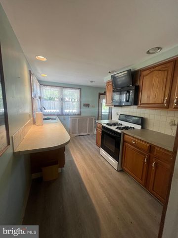 a kitchen with stainless steel appliances a sink stove and cabinets