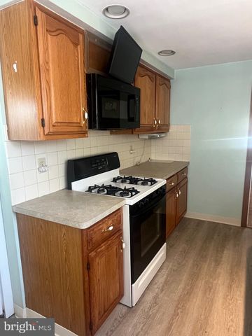 a kitchen with stainless steel appliances a stove a microwave a sink and cabinets