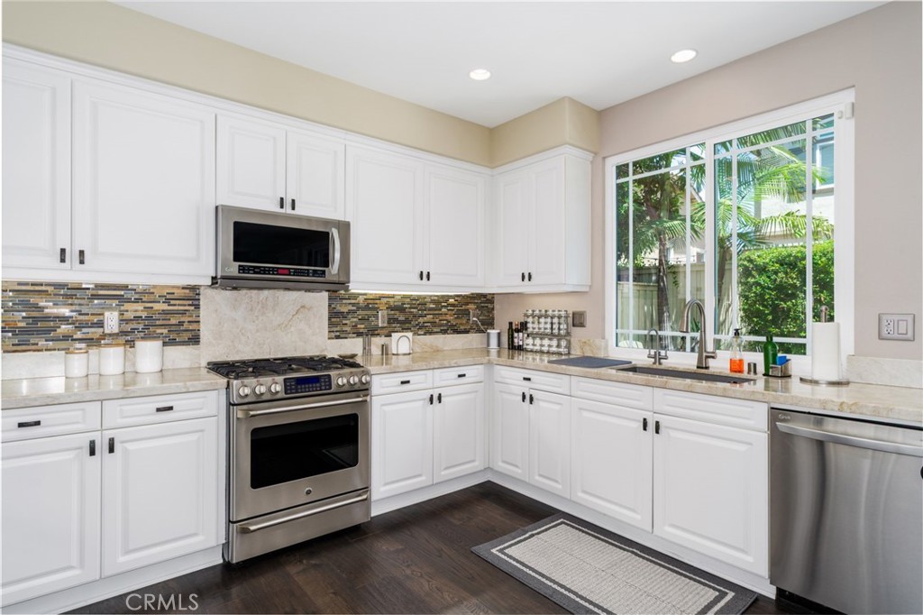 12931 MacKenzie Drive Tustin, CA 92782 - Photo 3 of 35 a kitchen with appliances a sink and cabinets