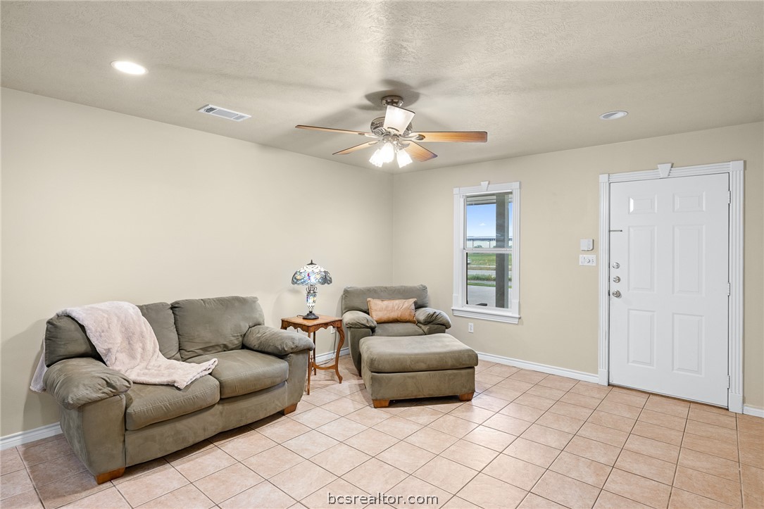 2287 North Earl Rudder Freeway Bryan, TX 77803 - Photo 13 of 32 a living room with furniture and a chandelier