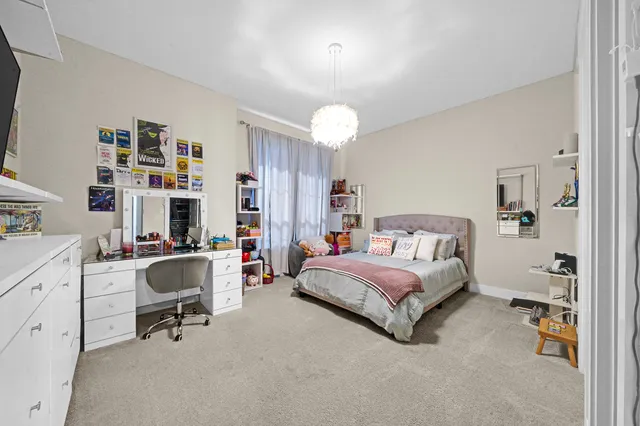 a spacious bedroom with a bed and a desk