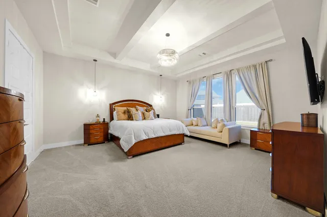 a bedroom with a bed couch and window