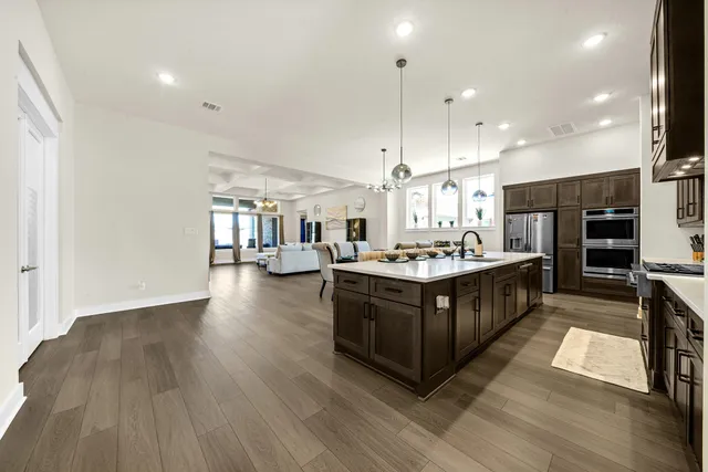 a bathroom with a sink a counter top space and stainless steel appliances